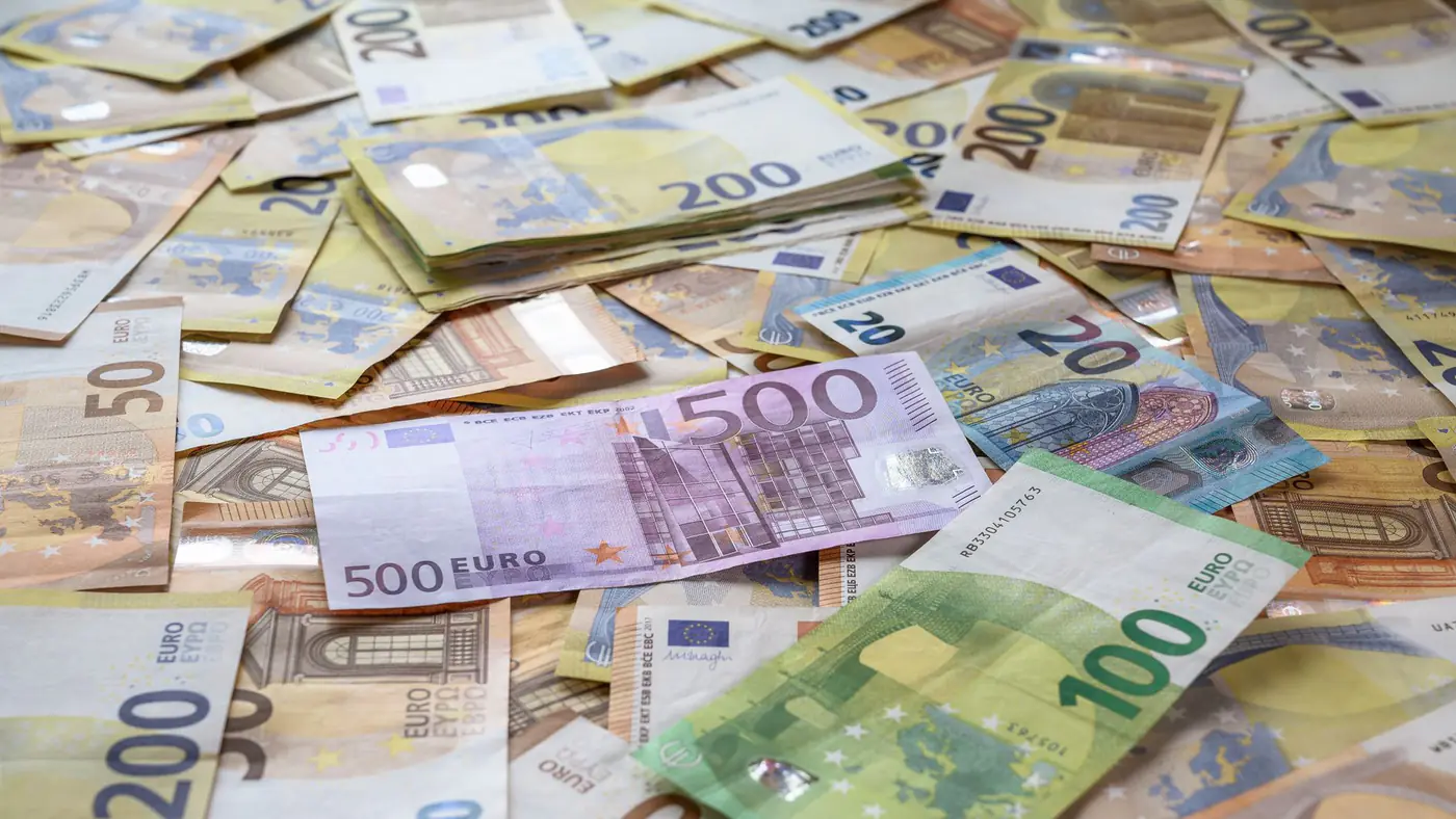 A collection of Euro banknotes representing wealth, savings, and European economy.